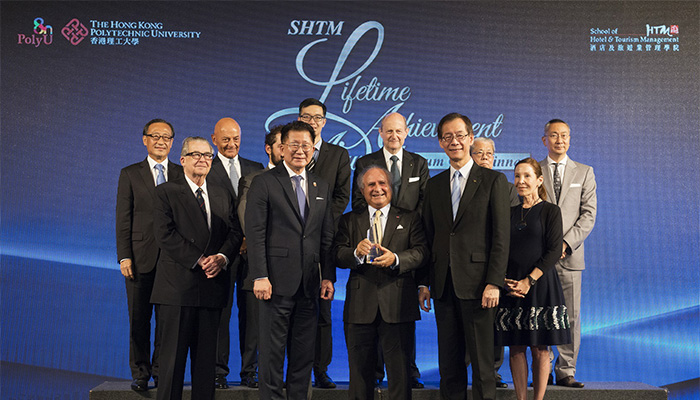 The Hon. Sir Michael Kadoorie (front row, middle) receiving the award from PolyU President Timothy W. Tong (front row, right) and SHTM Dean Kaye Chon (front row, left)