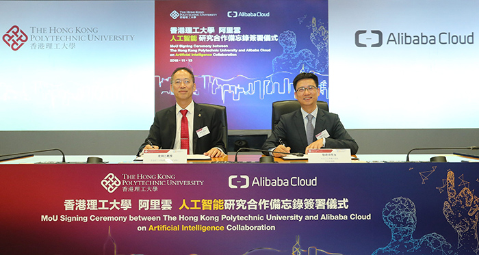 Professor Alex WAI, PolyU’s Vice President (Research Development), (left) and Mr Simon HU,  Senior Vice President of Alibaba Group and President of Alibaba Cloud sign the MoU on behalf of the two parties.