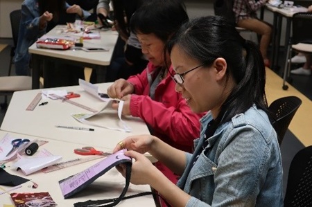 Participants turn snack wrappers into coins bag