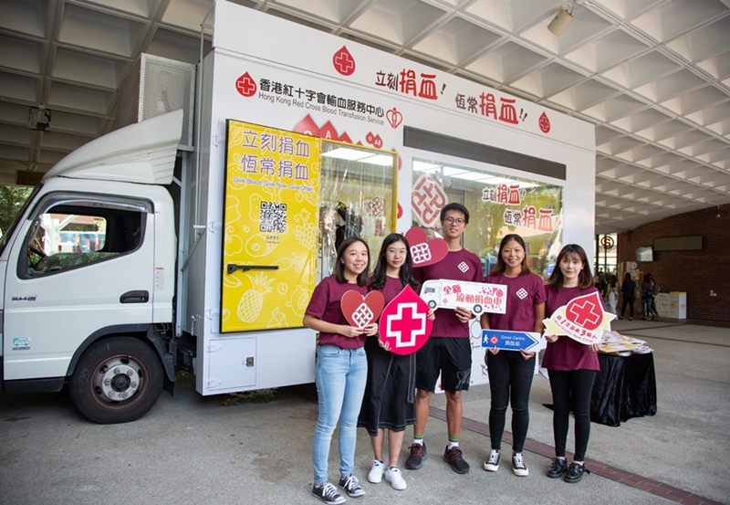 Students donating blood in the new blood donation vehicle