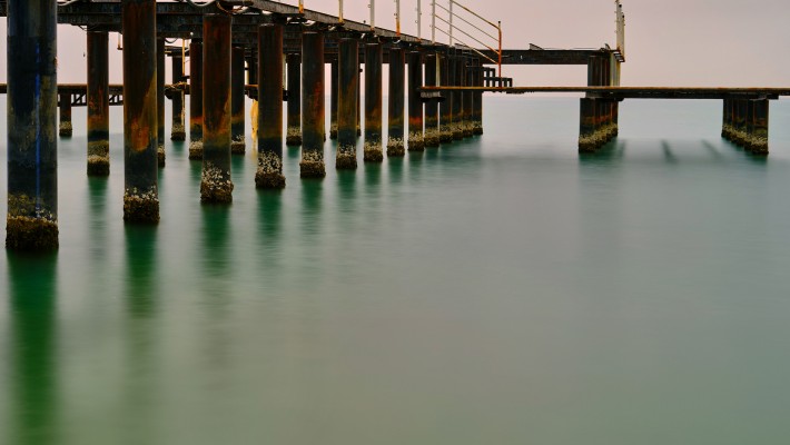 Coating biomineralised bacteria on marine infrastructure to keep it intact